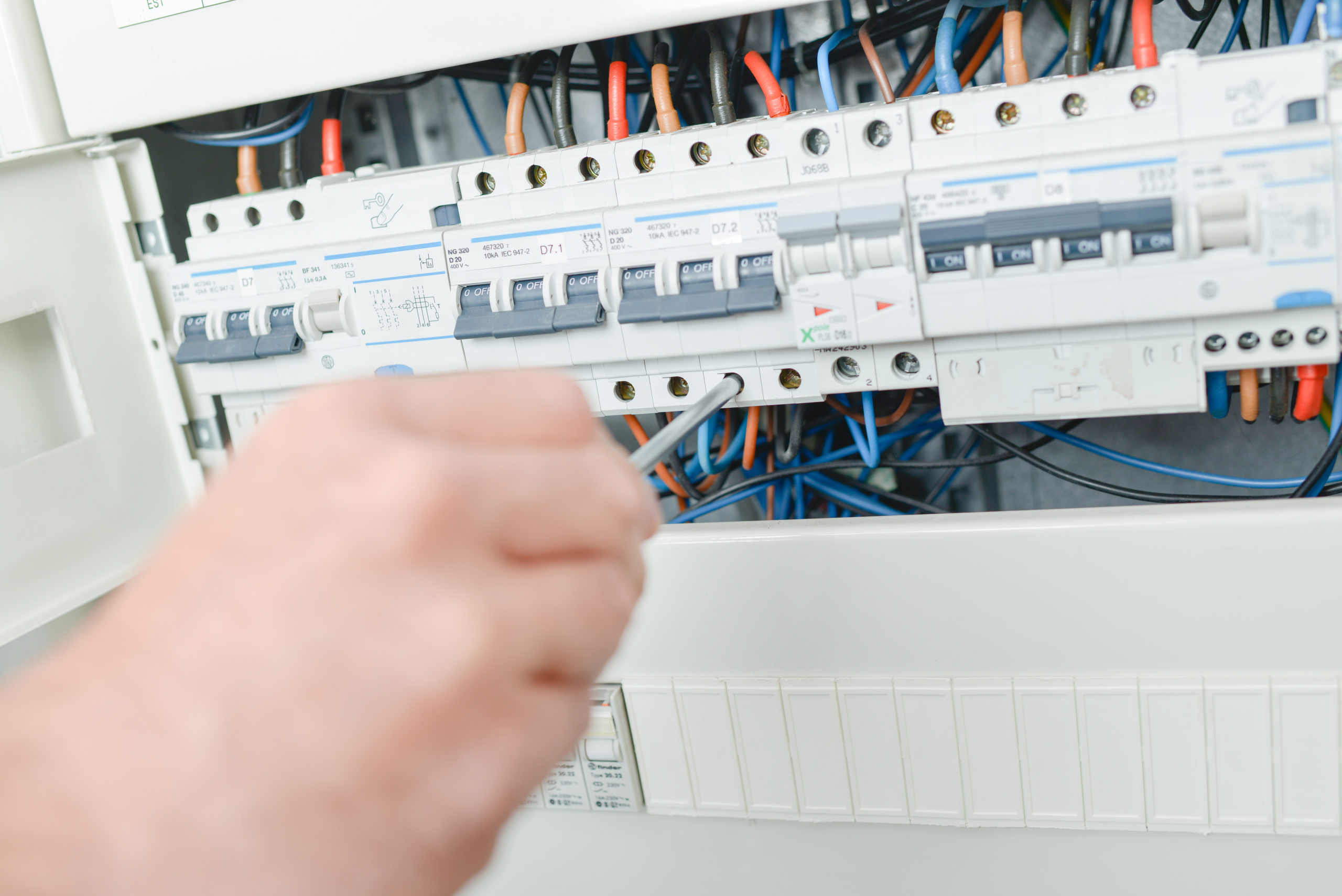 Electrician repairing a fuse